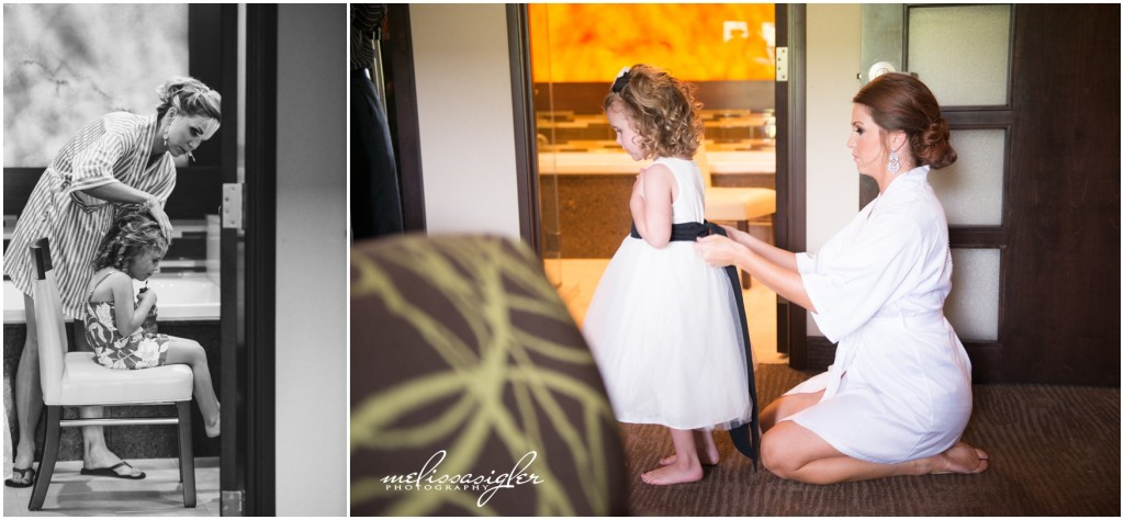 Bride helps flower girl put on dress at Prairie Band Casino and Resort by Melissa Sigler Photography