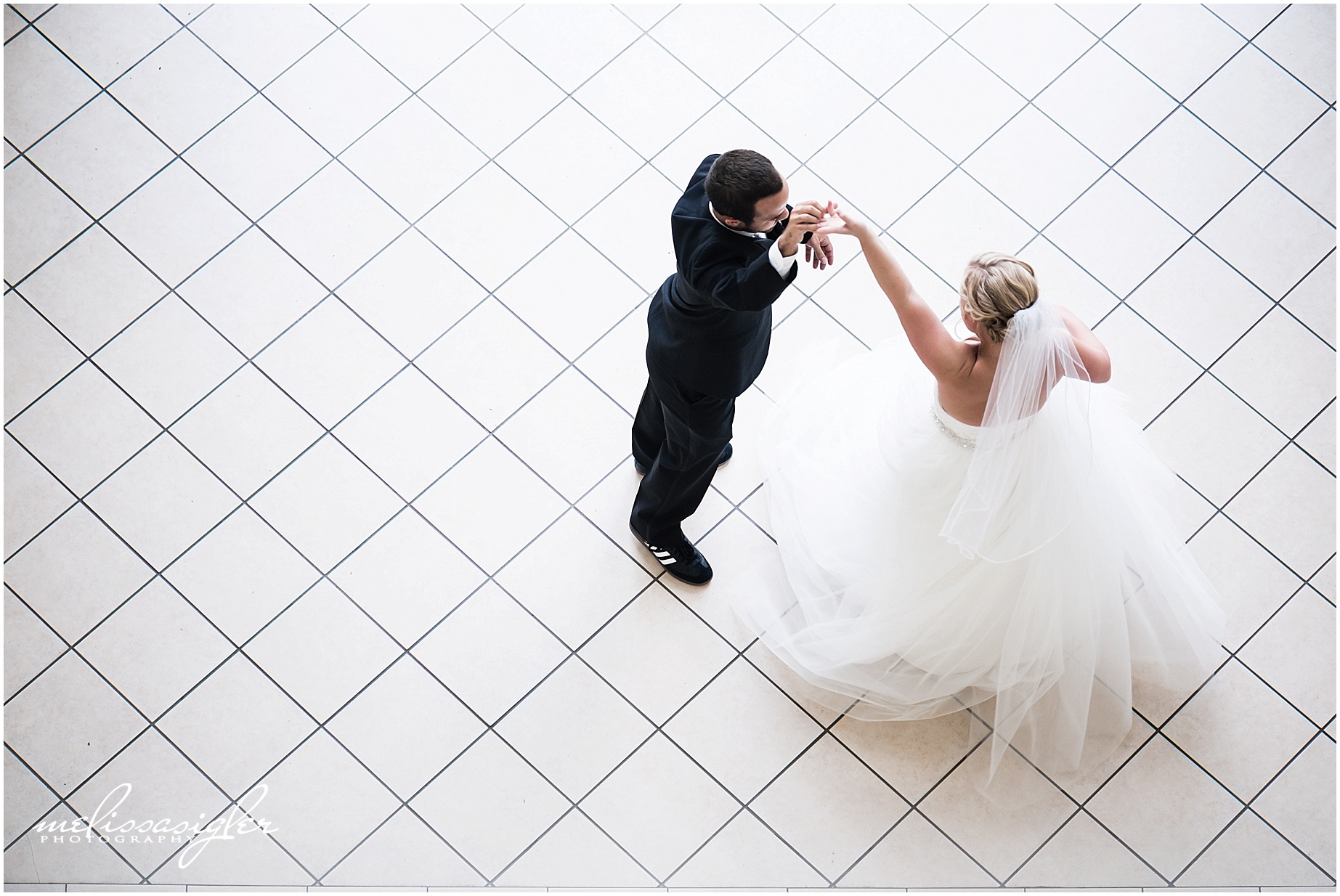 Bride and groom dancing in Lawrence kansas by wedding photographer Melissa Sigler