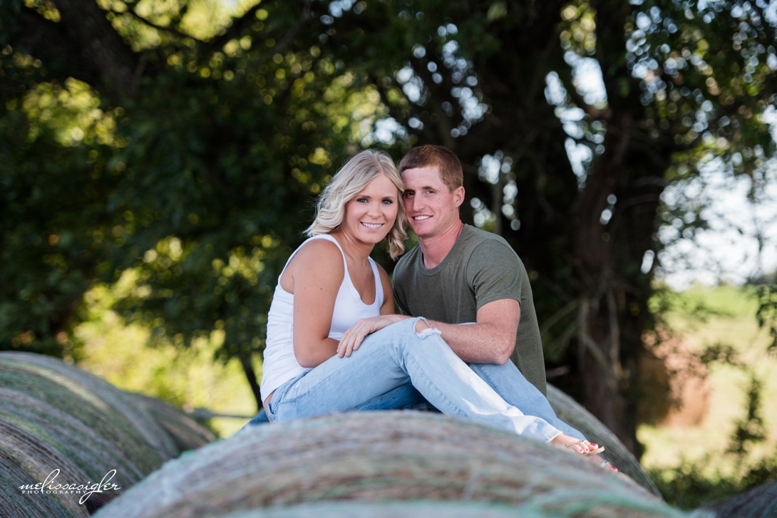 engagement pictures on a hay bale