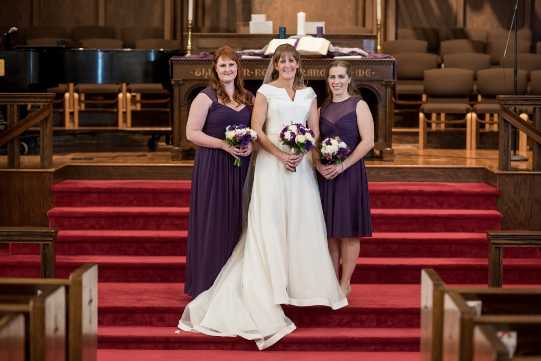 Bride and bridesmaids at the altar