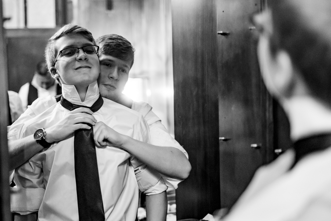 groomsmen helping each other get ready