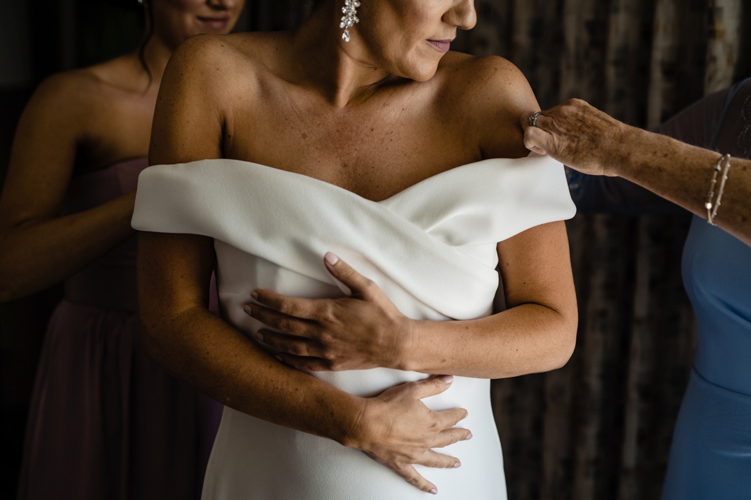 bride putting on gown