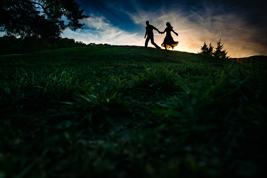 engaged couple silhouette in front of kansas sunset 
