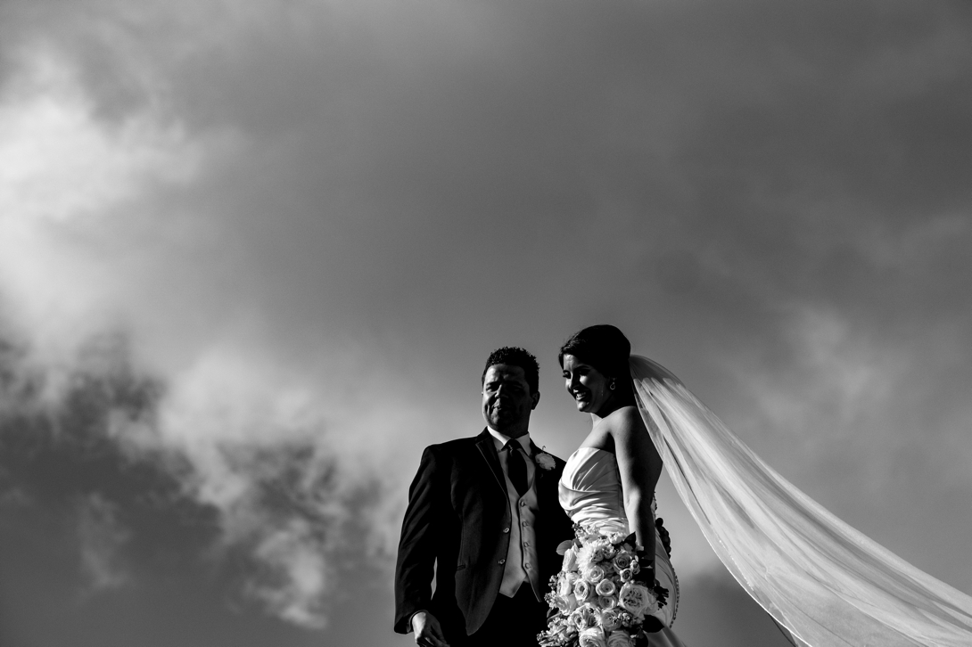 Black and white dramatic photo of bride and groom