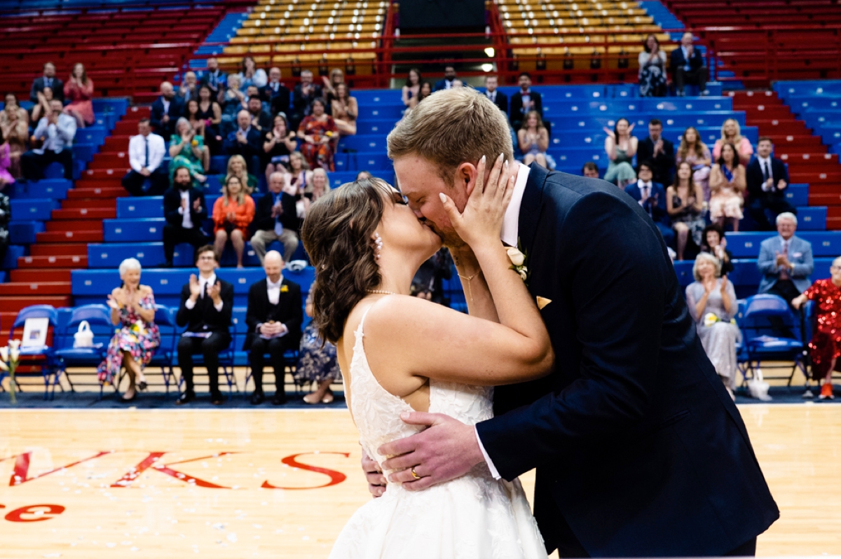 bride and groom kissing at allen fieldhouse