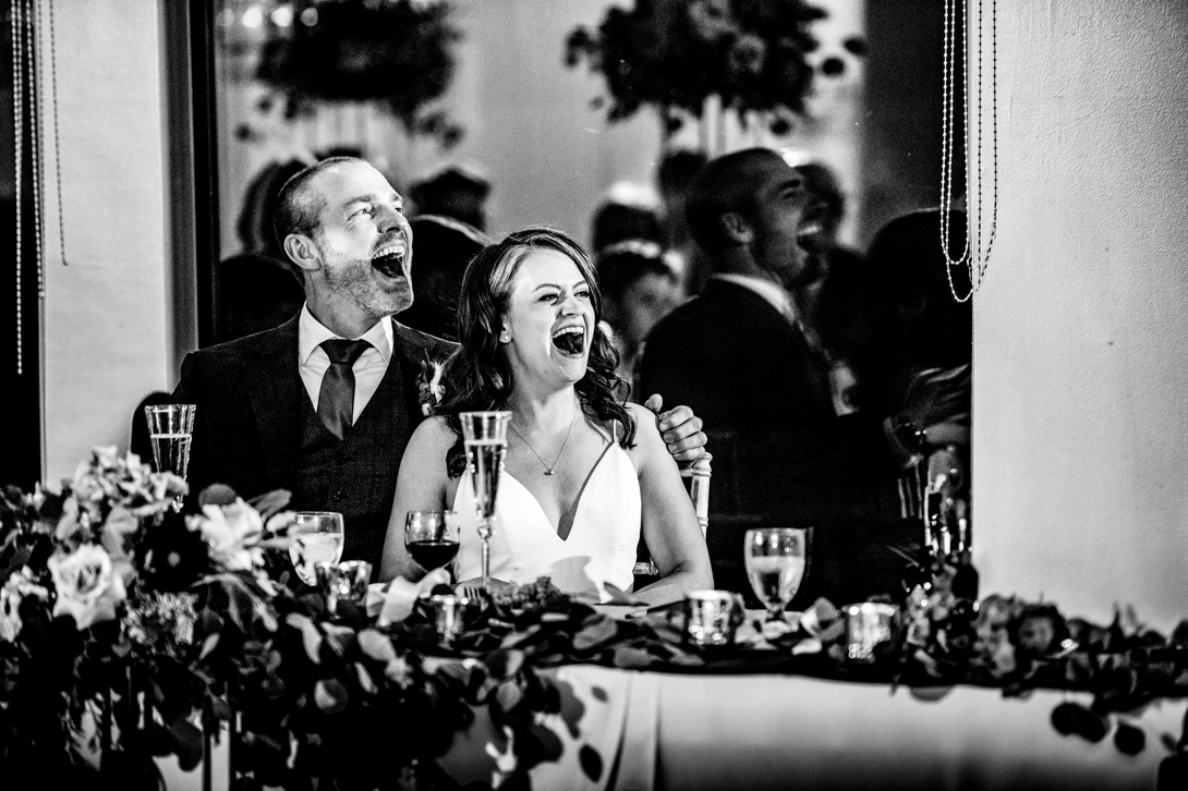 bride and groom laughing at wedding
